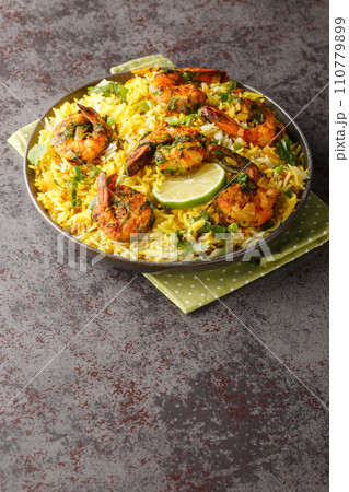 Meygoo Polo pilaf Rice with herbs and prawns closeup on the plate. Vertical 110779899