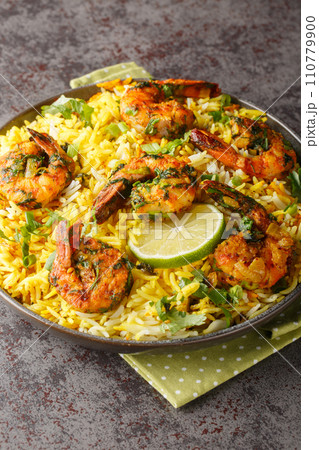 Persian style shrimp rice with lots of herbs and spices closeup on the plate. Vertical Persian style shrimp rice with lots of herbs and spices closeup on the plate. Vertical 110779900