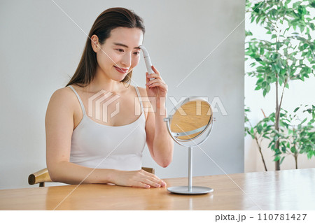 電気シェーバーで顔を剃る30代女性 電気シェーバーで顔を剃る30代女性 110781427