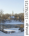 Winter city landscapes of Kuldiga, Latvia. Ancient buildings through a pattern of trees. Vertical frame. he Evangelical Lutheran Church of Saint Catherine. View from across the Venta Rive. High 110782725