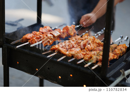 Bar-B-Q or BBQ with kebab cooking. Charcoal grill of meat skewers. Bar-B-Q or BBQ with kebab cooking. Charcoal grill of meat skewers. 110782834