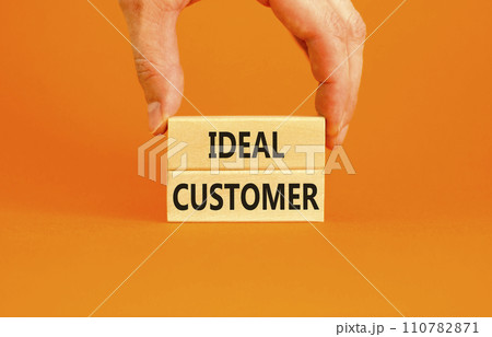 Ideal customer symbol. Concept words Ideal customer on beautiful wooden blocks. Beautiful orange table orange background. Businessman hand. Business ideal customer concept. Copy space. 110782871