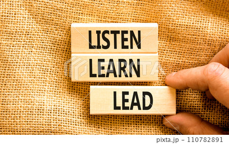 Listen learn lead symbol. Concept word Listen Learn Lead on beautiful wooden block. Businessman hand. Beautiful canvas table canvas background. Business education listen learn lead concept. Copy space 110782891