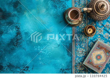 Ramadan holiday banner with candle and teapot. Top view on blue background with copy space 110784425