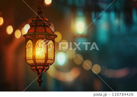 Ornamental Arabic lantern with burning candle in the evening Ornamental Arabic lantern with burning candle in the evening 110784426
