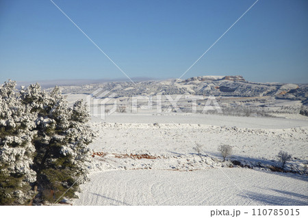 Snow. Winter landscape covered in a white blanket of snow covering mountains and roads. Trees with snow. Clear day. White blanket due to a storm with heavy snowfall. In Spain. January. 2024. Snow. Winter landscape covered in a white blanket of snow covering mountains and roads. Trees with snow. Clear day. White blanket due to a storm with heavy snowfall. In Spain. January. 2024. 110785015