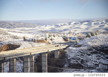 Snow. Winter landscape covered in a white blanket of snow covering mountains and roads. Trees with snow. Clear day. White blanket due to a storm with heavy snowfall. In Spain. January. 2024. Snow. Winter landscape covered in a white blanket of snow covering mountains and roads. Trees with snow. Clear day. White blanket due to a storm with heavy snowfall. In Spain. January. 2024. 110785033
