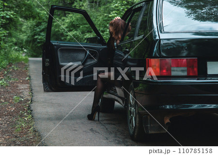 beautiful girl in short shorts near the car. sexy girl in shorts and tights. girl gets out of the car beautiful girl in short shorts near the car. sexy girl in shorts and tights. girl gets out of the car 110785158