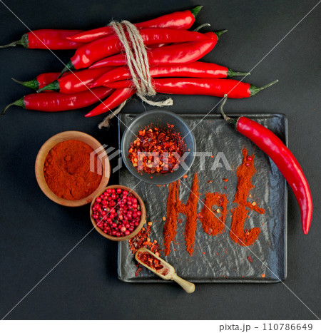 Chili pepper isolated on a black background. Knitted hot chili pepper tied with a rope. Chili hot pepper clipping path 110786649