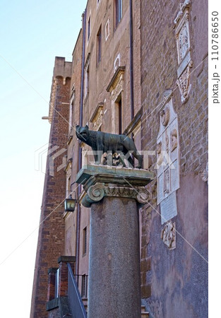 Ancient roman bronze statue of a she-wolf feeding Romulus and Remus the traditional founders of the city and empire of Rome, Italy 110786650