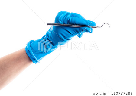 Hand in blue glove holding dental metal stick isolated 110787283