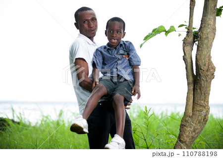 Young father playing with his son in his arms 110788198