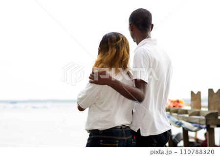 young couple standing on a dock at the edge of the lagoon. young couple standing on a dock at the edge of the lagoon. 110788320