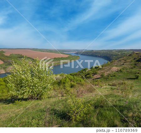 Amazing spring view on the Dnister River Canyon with picturesque rocks, fields, flowers. This place named Shyshkovi Gorby, Nahoriany, Chernivtsi region, Ukraine. Amazing spring view on the Dnister River Canyon with picturesque rocks, fields, flowers. This place named Shyshkovi Gorby, Nahoriany, Chernivtsi region, Ukraine. 110789369