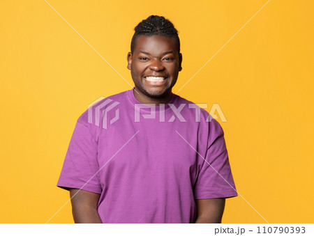 Portrait Of Black Man Smiling To Camera Posing In Studio 110790393