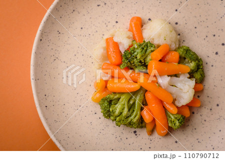 Delicious fresh vegetables broccoli, cauliflower, carrots steamed with salt and spices Delicious fresh vegetables broccoli, cauliflower, carrots steamed with salt and spices 110790712