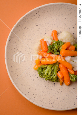 Delicious fresh vegetables broccoli, cauliflower, carrots steamed with salt and spices 110790713