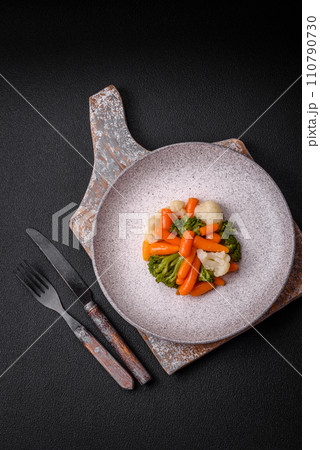 Delicious fresh vegetables broccoli, cauliflower, carrots steamed with salt and spices 110790730