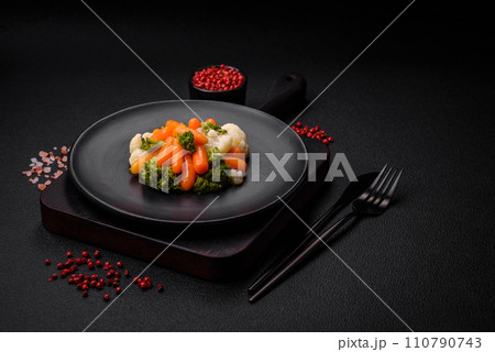 Delicious fresh vegetables broccoli, cauliflower, carrots steamed with salt and spices 110790743