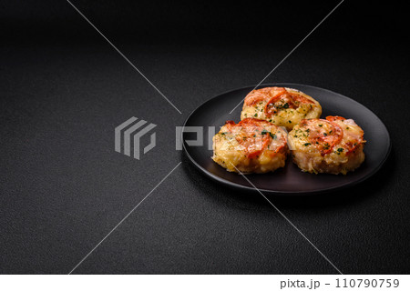 Delicious baked fish fillet with cheese, tomatoes, salt, spices and herbs 110790759