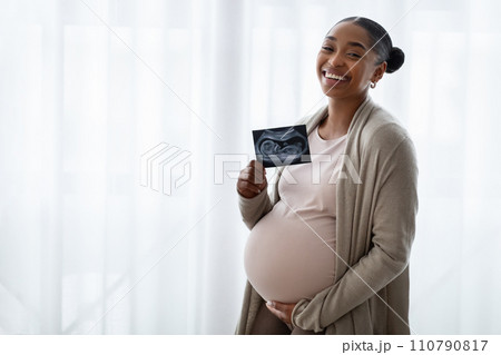Happy Black Pregnant Lady Holding Ultrasound Photo Of Her Baby Happy Black Pregnant Lady Holding Ultrasound Photo Of Her Baby 110790817
