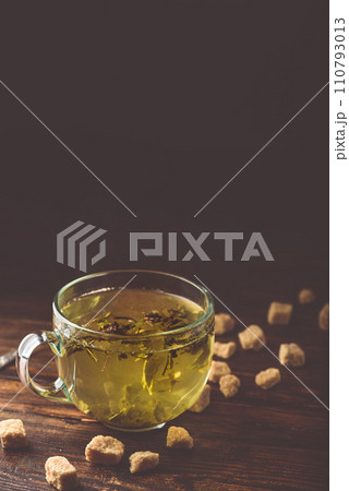 Cup of green tea with brown tea sugar 110793013