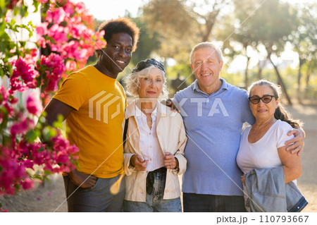 Portrait of happy multiracial friendly mature adult people standing outdoors bonding and posing 110793667