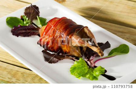 Photography of plate with baked in bacon quail with balsamic sauce Photography of plate with baked in bacon quail with balsamic sauce 110793758