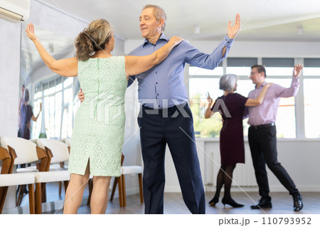 Senior man and elderly woman are dancing classic version of waltz in couple Senior man and elderly woman are dancing classic version of waltz in couple 110793952