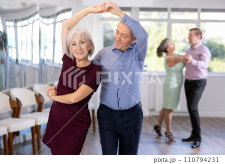 Senior man and elderly woman are dancing classic version of waltz in couple 110794231