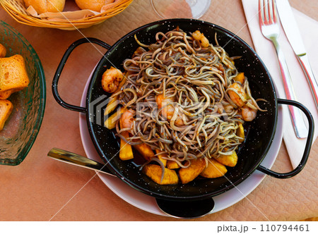 Spainsh dish seafood fried baby eels and prawns with potatoes 110794461