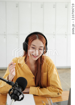 Female podcaster making audio podcast from her home studio 110799719