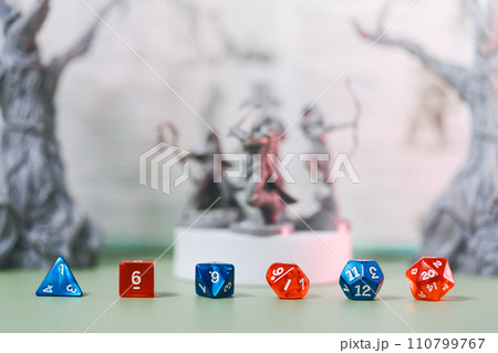 Blue and red dice place on adventure story TTRPG book role playing tabletop game and board game 110799767