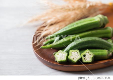 Green okra on wooden plate prepare for cooking, Organic vegetables Green okra on wooden plate prepare for cooking, Organic vegetables 110800406