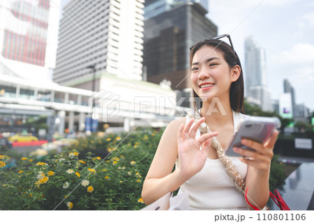 Asian woman city lifestyles using smartphone and shopping with internet banking Asian woman city lifestyles using smartphone and shopping with internet banking 110801106