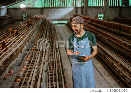Asian entrepreneur at work writing on a clipboard at farm 110801146