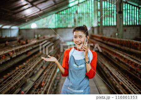Asian woman entrepreneur chats on phone call with hand presenting 110801353