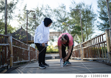 asian women taking rest after jogging 110801489