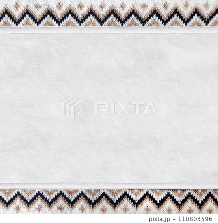 Horizontal or vertical backdrop with suede texture and border of wool material with knitted ornament. Background for scrapbooking with suede leather and sweater knitted texture. Copy space for text 110803596