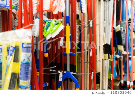 Large assortment of brushes for cleaning premises in the store. Trade in floor cleaning equipment Large assortment of brushes for cleaning premises in the store. Trade in floor cleaning equipment 110803646