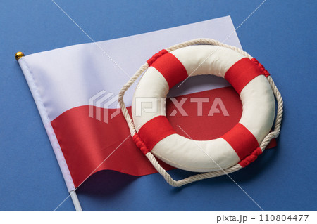 Lifebuoy and Poland flag on a colored background, concept on the theme of help 110804477