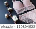 woman pink lace bra, panties lingerie with cotton buds on black. Shopping-fashion wardrobe concept 110804622