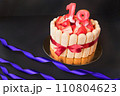 18 birthday party. strawberry tiramisu cake on black background with ribbon. Focus on strawberries. 110804623