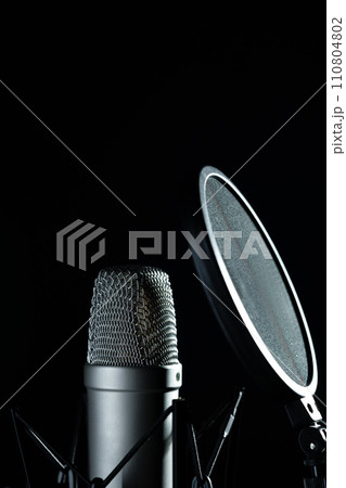 Professional microphone against black background in studio 110804802