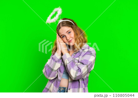 Portrait of smiling shy angelic young woman with angel halo nimb over head, positive love emotions Portrait of smiling shy angelic young woman with angel halo nimb over head, positive love emotions 110805044