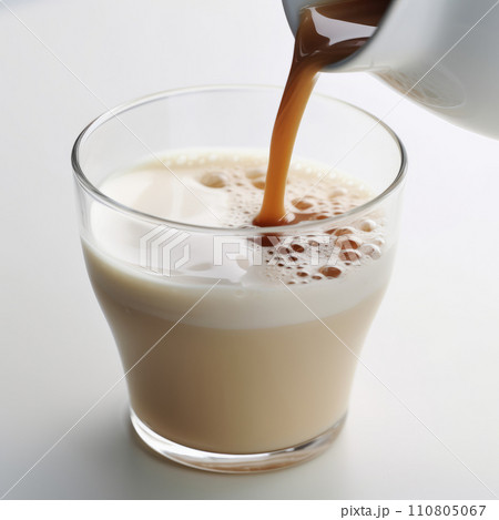Pouring milk chocolate into a glass 110805067