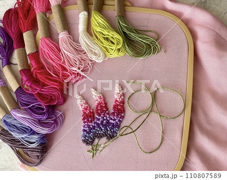 embroidery of flowers in French knot technic, canvas, threads mouline and needle 110807589