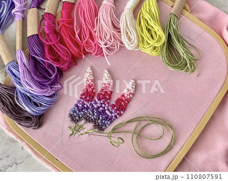 embroidery of flowers in French knot technic, canvas, threads mouline and needle 110807591