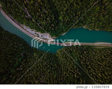 Aerial view of big metal railway bridge across river, in the middle of summer forest. 110807859