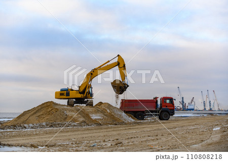 Yellow excavator working on construction site. The road construction. 110808218